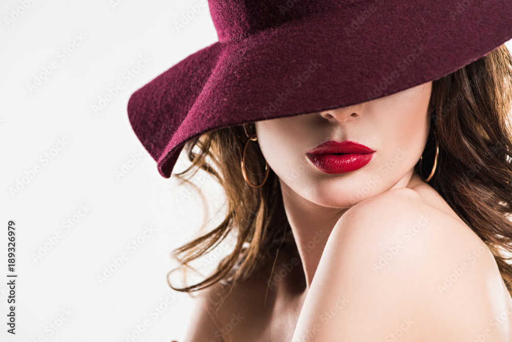 passionate woman with red lips hiding eyes under burgundy hat isolated on white passionate woman with red lips hiding eyes under burgundy hat isolated on white