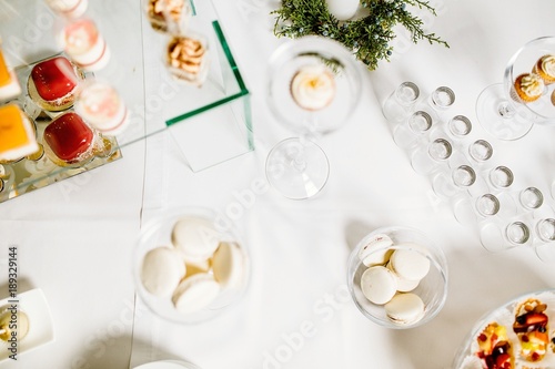 Wedding reception dessert table with delicious decorated white c