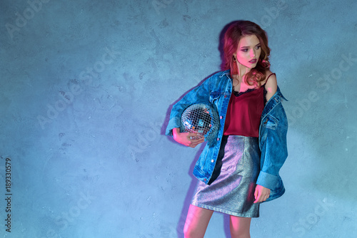  portrait of attractive young woman with disco ball