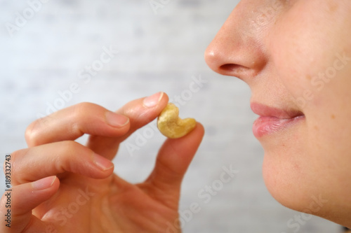 Close-up of woman eating cashew nuts