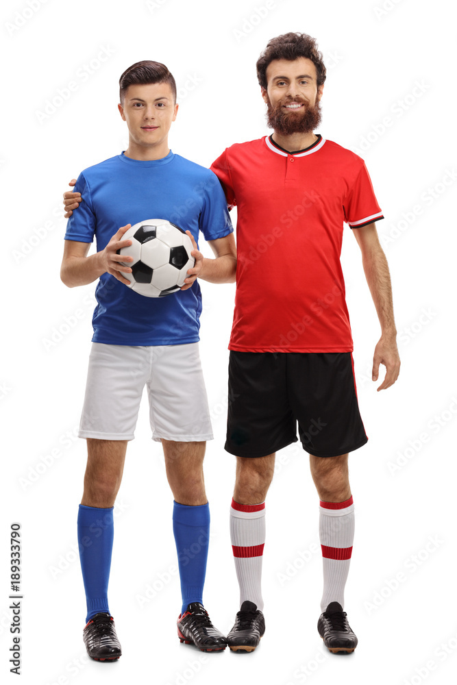 Teenage boy and his father with a football dressed in sportswear