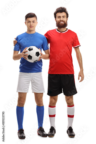Teenage boy and his father with a football dressed in sportswear © Ljupco Smokovski