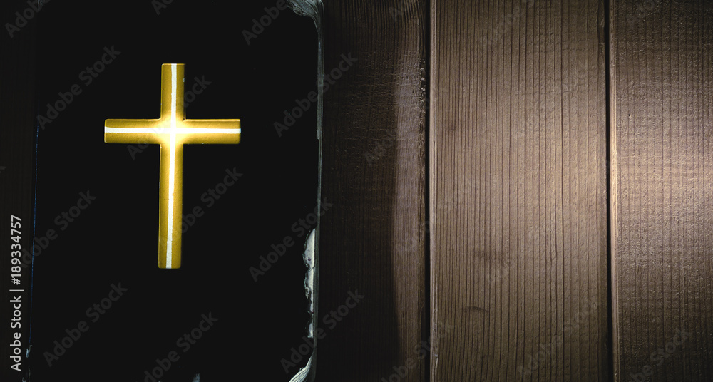 Light of cross on holy bible with wooden.Christian, Christianity, Religion background.