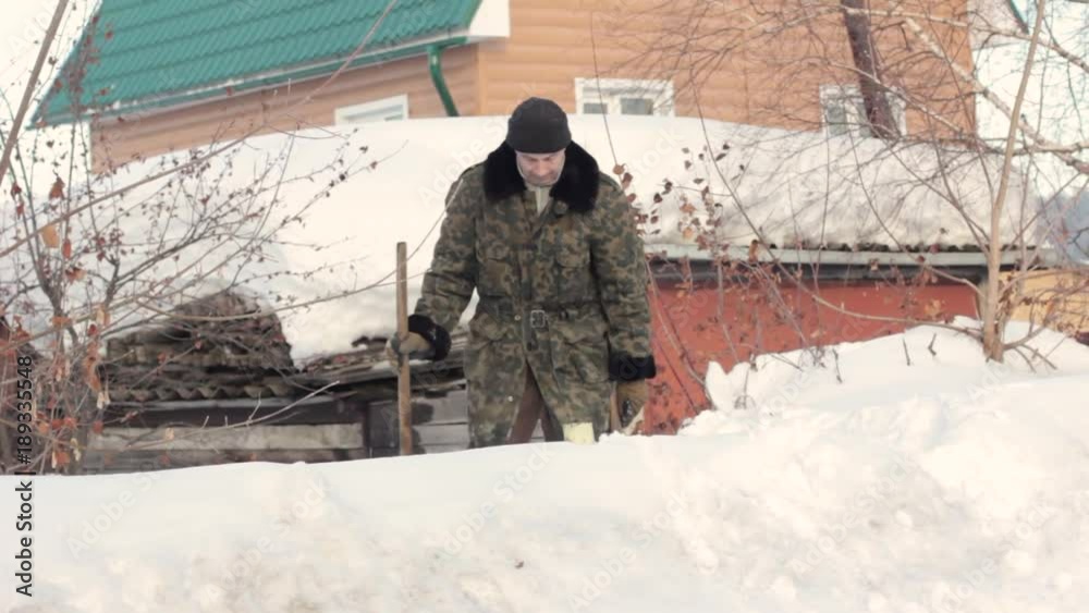 a man stands in the snow in the village a man stands in the snow in the village