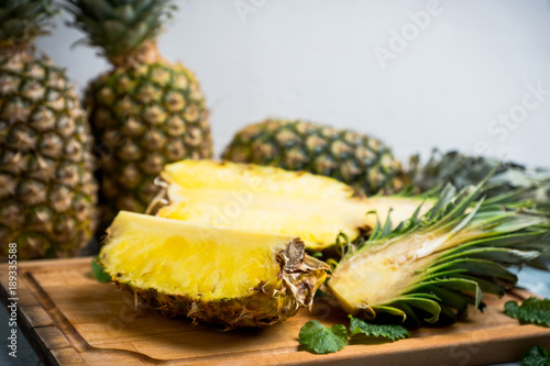Fresh ripe pineapples on the rustic background. Selective focus.