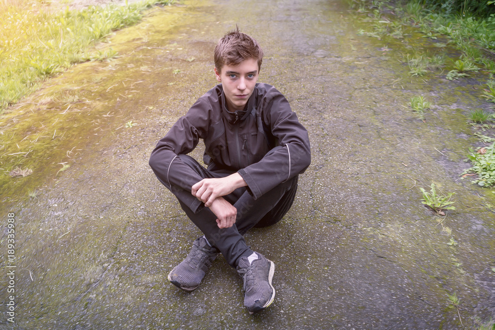 Portrait of a young man who is sitting on a way Portrait of a young man who is sitting on a way