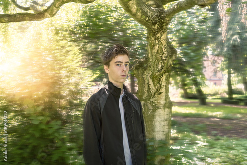 Portrait of a young man in a dreamy garden