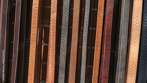 some hanging leather belts in a store
