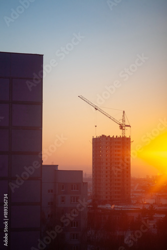 View of the construction of a house at sunset.