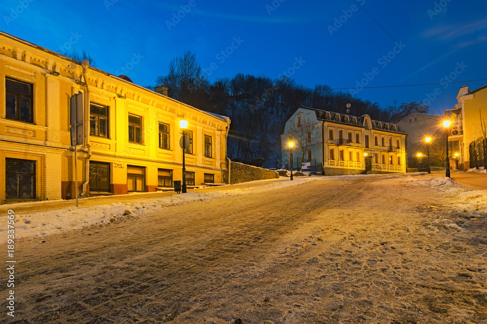 KYIV, UKRAINE-JANUARY 21, 2018: An early morning view of colourful buildings on empty Andriyivskyy Uzvoz (Descent or Spusk). One of the oldest street in Kyiv