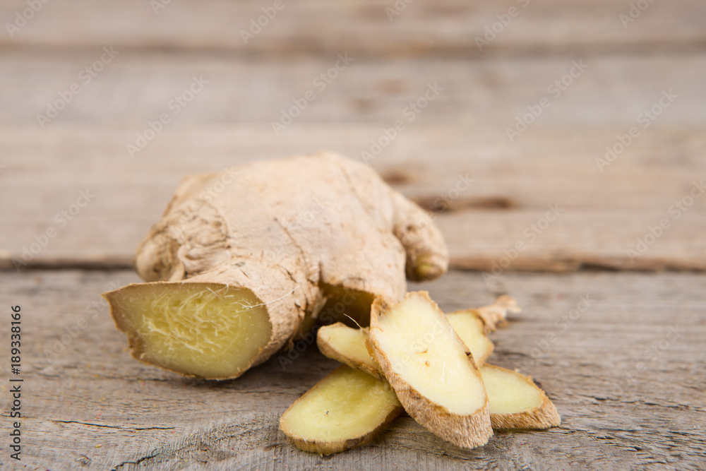 Fototapeta premium Ginger tea in a cup on wooden background