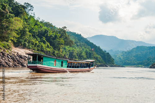 Travel down the Mekong to Luang Prabang with a wooden boat, Laos, South East Asia.