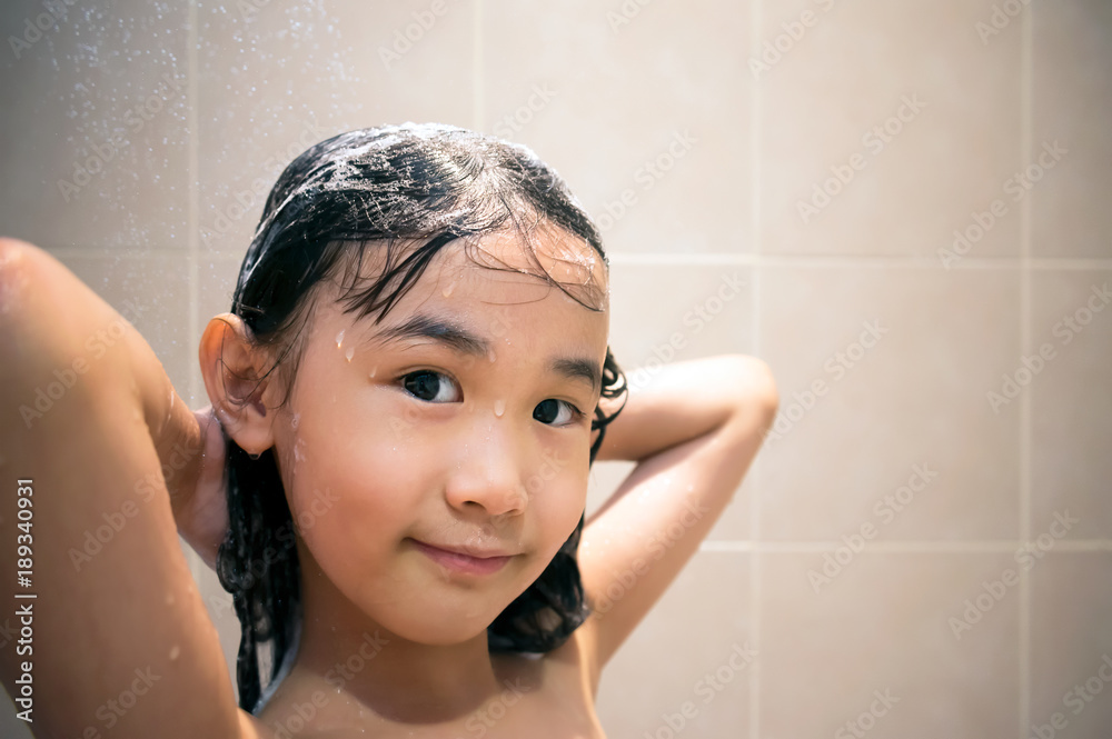 Young Asian Little Girl Washing Hair with Soap and Shampoo in the Shower.  Stock Photo | Adobe Stock