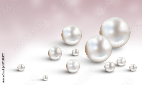 Many small and big white pearls on white and mauve background