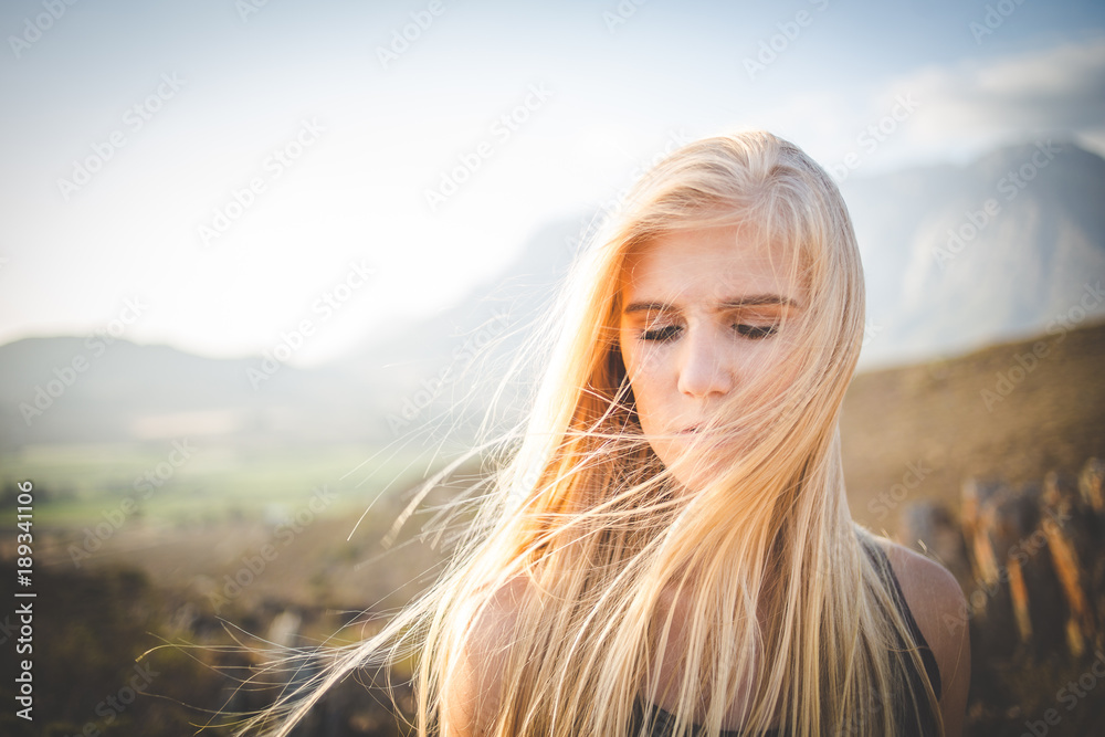 Portrait of a beautiful blond female model in a natural setting with stunning back light Portrait of a beautiful blond female model in a natural setting with stunning back light