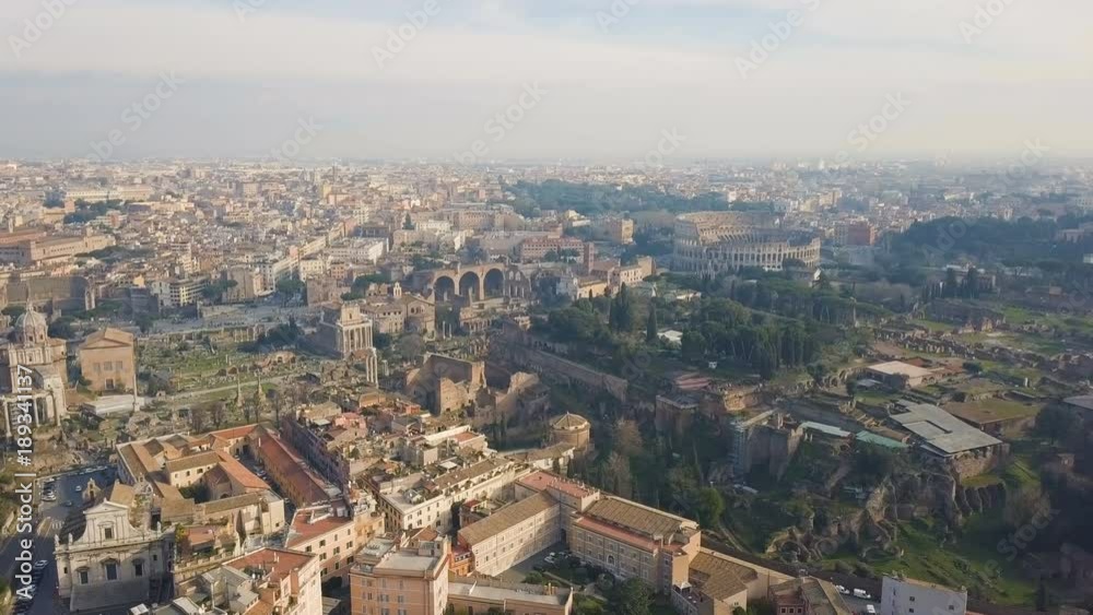 Cityscape of Rome. Aerial view of Colosseum and ancinet Roman ruins Cityscape of Rome. Aerial view of Colosseum and ancinet Roman ruins