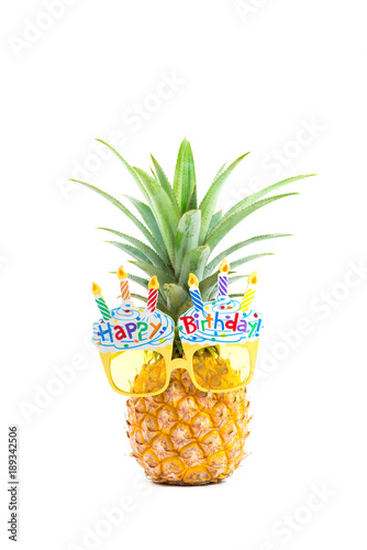 Canvas Print yellow fancy glasses on fresh pineapple, white background, summer birthday conce