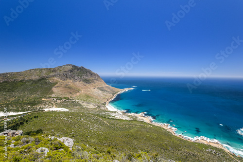 Stunning wide angle panoramic view of Sandy Bay Beach near Llandudno and Hout Bay, little towns in the Cape Town area, South Africa, seen from the summit of Little Lion's Head Mountain.