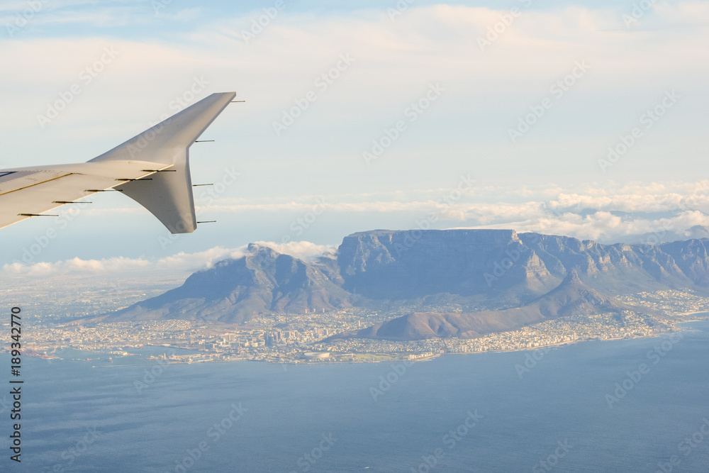 Obraz premium Stunning aerial view of Cape Town, South Africa, with Table Mountain, Lion's Head, Signal Hill and the coastline. Seen from a landing airplane.