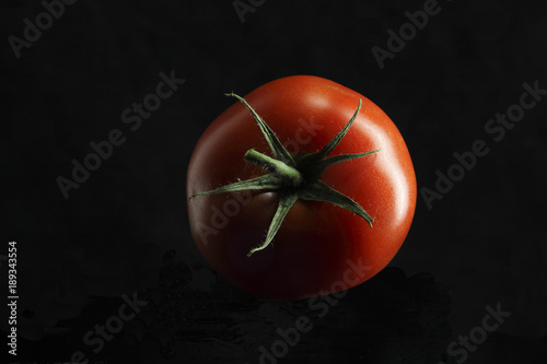 round tomato on black background