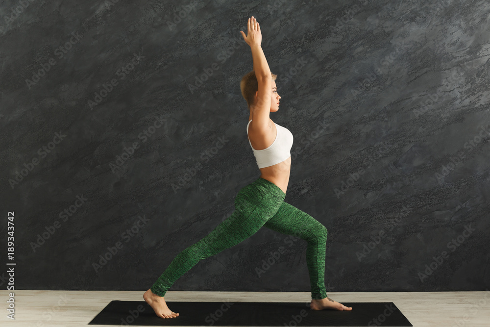 Woman training yoga pose in gym Woman training yoga pose in gym