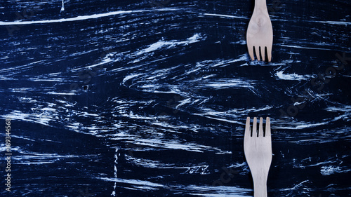 Silver fork lying on a wooden table. Cutlery for eating. Device  photo