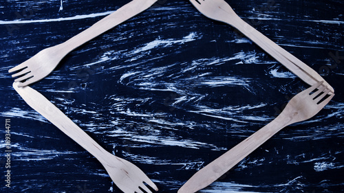 Silver fork lying on a wooden table. Cutlery for eating. Device  photo