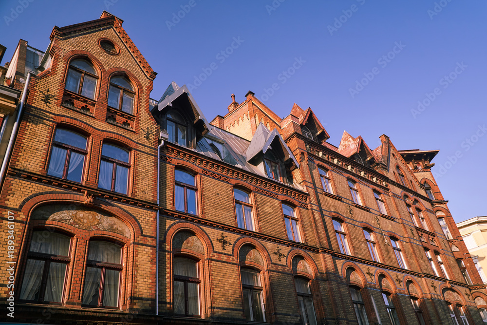 The facade of old red brick building in Poznan.