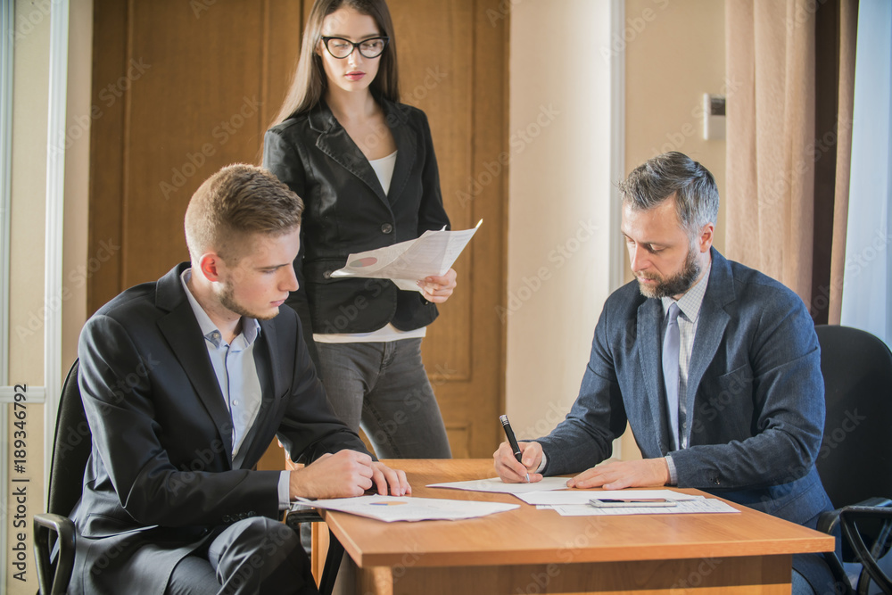 three businessmen at the meeting to communicate three businessmen at the meeting to communicate