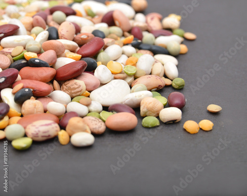 A mixture of legumes , black background.