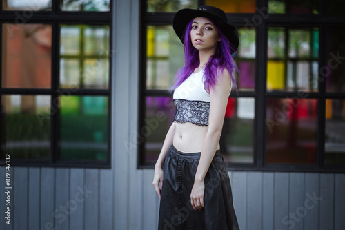 Beautiful young violet hairy girl walking at sunset in a city park. St. Petersburg, New Holland