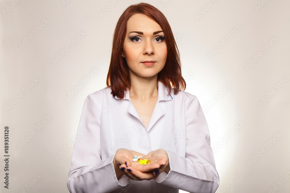 Healthcare and medicine. Woman Doctor, nurse with pills in his hands isolated on white background Healthcare and medicine. Woman Doctor, nurse with pills in his hands isolated on white background