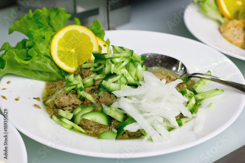 Salad of canned tuna with cucumbers and onions
