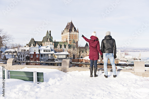 Young couple outside in winter with Quebec city Chateau frontenac © Louis-Photo
