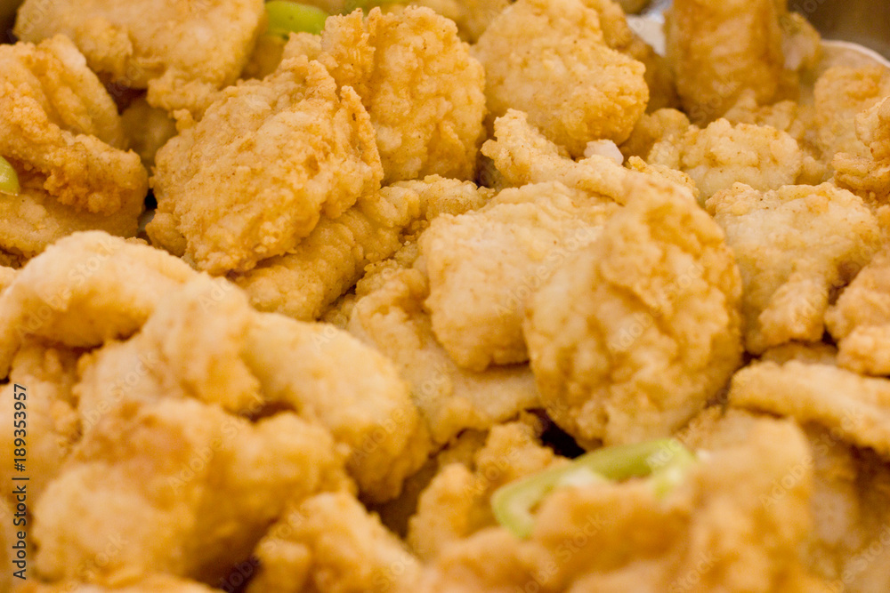 Pieces of fish in brown breadcrumbs decorated with rings of sweet green pepper Pieces of fish in brown breadcrumbs decorated with rings of sweet green pepper