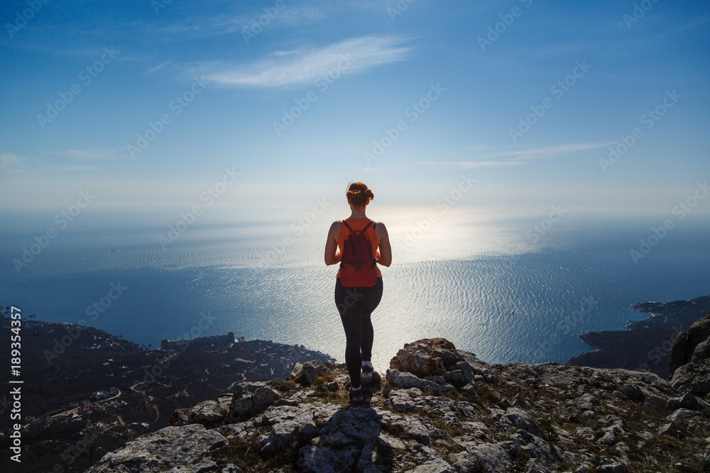 young fitness woman trail runner on sunrise seaside trail