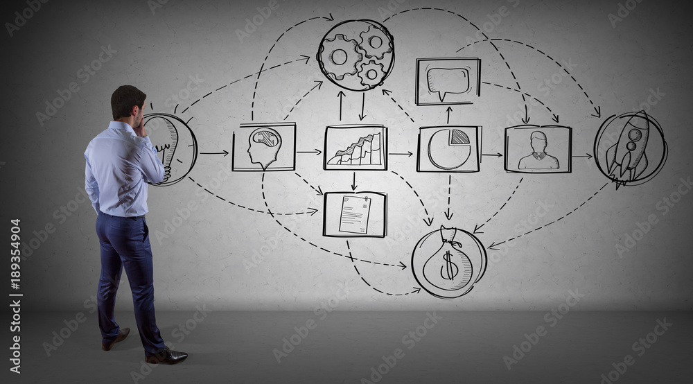 Businessman watching a project sketch on a wall 3D rendering Businessman watching a project sketch on a wall 3D rendering