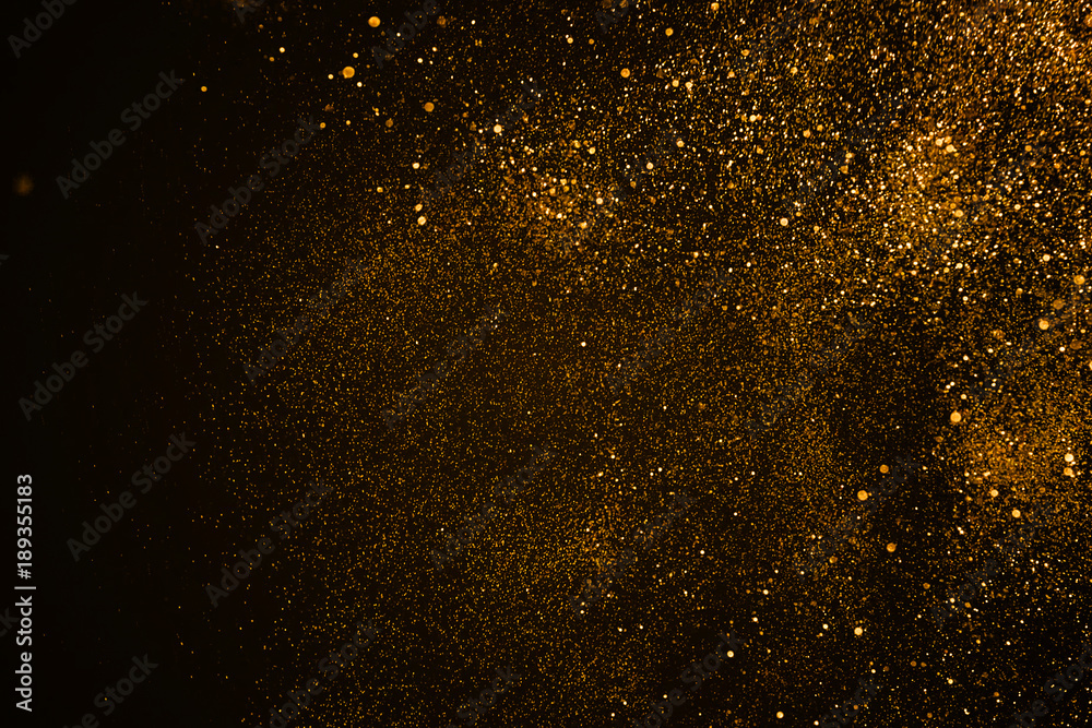 christmas gold sparkle glitter explosion dust particles background with bokeh, gold holiday happy new year and valentine day concept - obrazy, fototapety, plakaty 