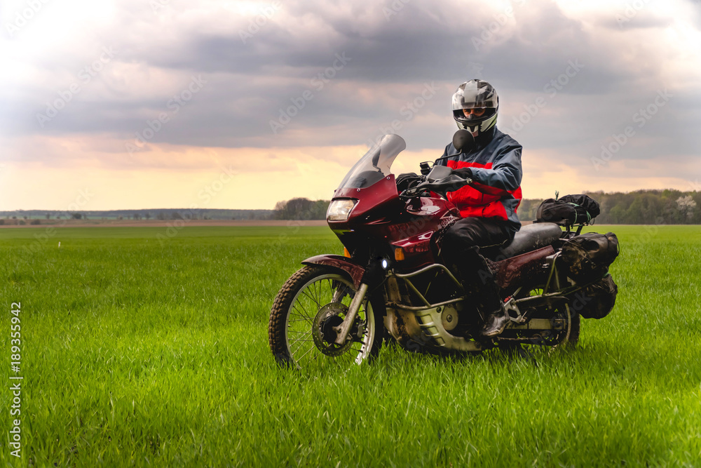 Fototapeta premium Motorcyclist on mountainous highway, cold overcast weather, Europe, Austria, Alps, extreme sport, active lifestyle, adventure touring concept