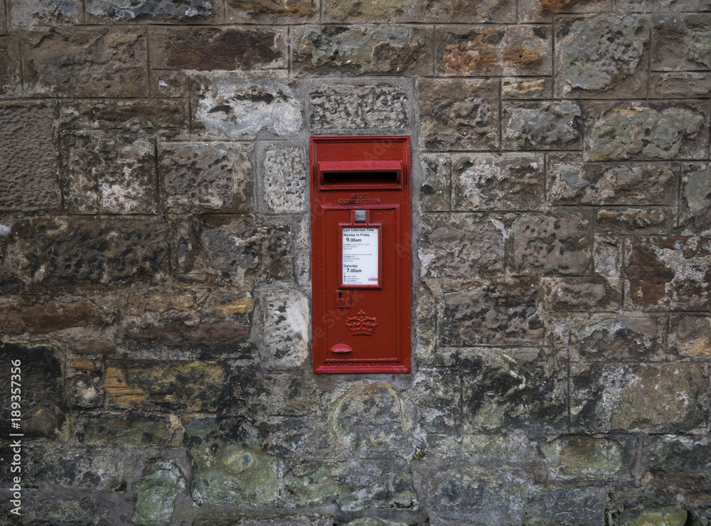 Red Royal Mail letterbox in a stone wall in Scotland Red Royal Mail letterbox in a stone wall in Scotland