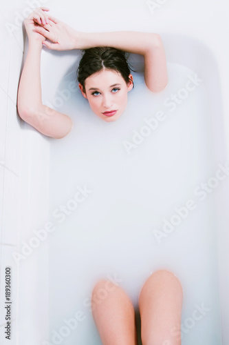 Beautiful young nude girl relaxing and enjoying in bath