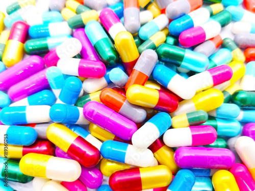 Medical and healthcare concept. Many colorful capsules of Antibiotic drug, that are on white background. Full frame, selective focus and copy space.