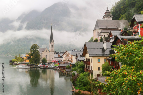 Scenic view of famous Hallstatt mountain village in the Austrian Alps with misty raining, Salzkammergut region, Austria