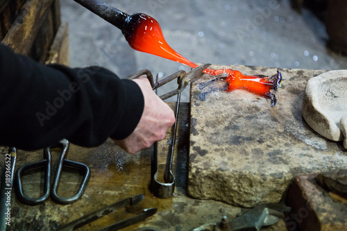 Artisan making glass vases and sculptures in Murano