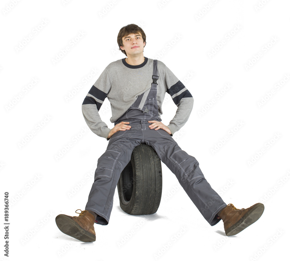 A young brunet foreman in working grey uniform with black wheel. A young brunet foreman in working grey uniform with black wheel.