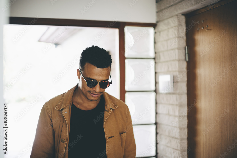 Smiling man wearing jacket walking in house Smiling man wearing jacket walking in house