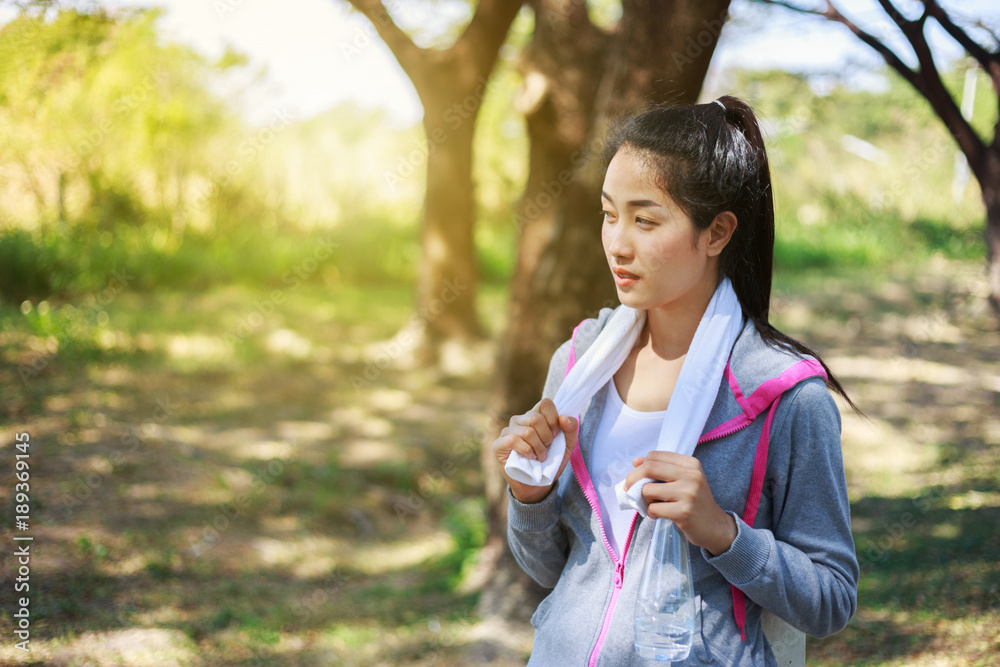 sporty woman with white towel resting after workout sport exercises outdoors at the park sporty woman with white towel resting after workout sport exercises outdoors at the park