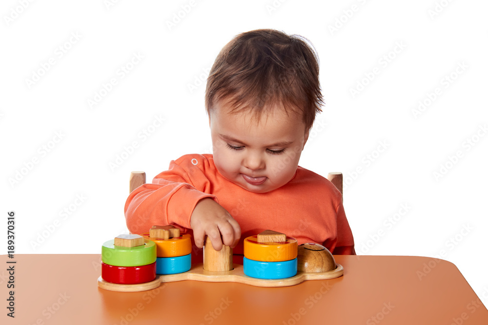 Child little girl learning to use colorful logic game isolated on white background Child little girl learning to use colorful logic game isolated on white background