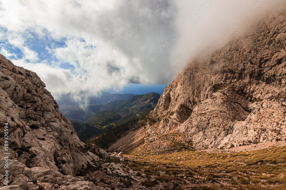 Mountain gorge covered by clouds in Serra de Tramuntana range, Majorca Balearic Islands
