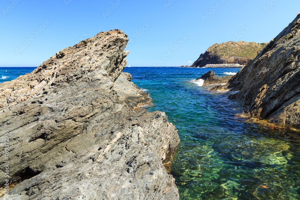 Rocky coast near tourist town Portbou (Costa Brava, Catalonia, Spain)